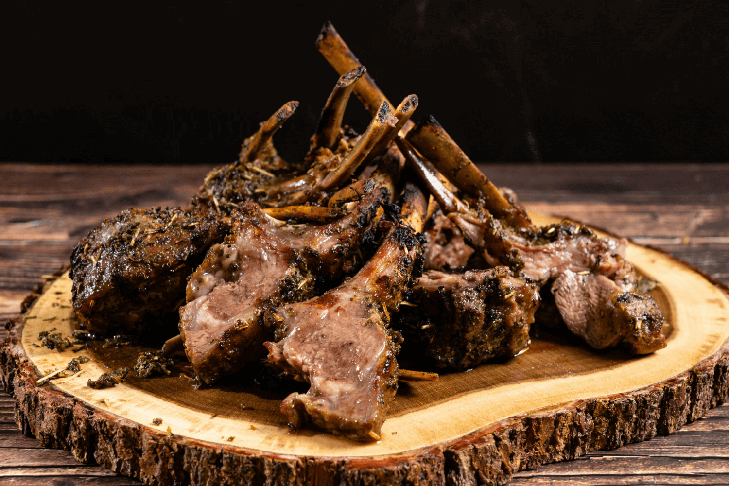 Grilled Irish lamb chops with golden herb crust, served with lemon wedges and fresh herbs
