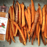 Smoky roasted sweet potato wedges seasoned with garlic, chili, and chives